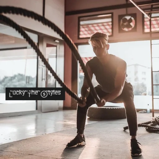 young man, gym, motion crossover, cross rope, fitness training