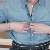 legs, men's belt, an unbuttoned belt, hand of a blue shirt, men's leather belt