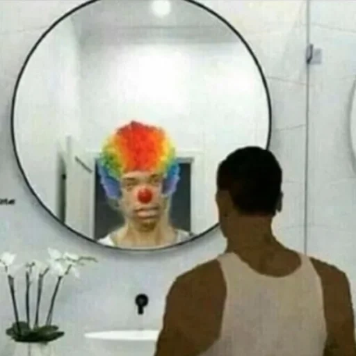 in the mirror, the face is funny, clown mirror, looks at the mirror, the clown looks a mirror