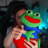 young woman, toy frog, frog pepe toy, pepe pepe, soft toy frog